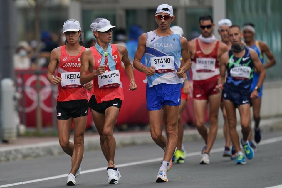 Ikeda Koki (L front) and Yamanishi Toshikazu (C front) of Japan and Massimo Stano of Italy compete during the men’s 20km race walk.