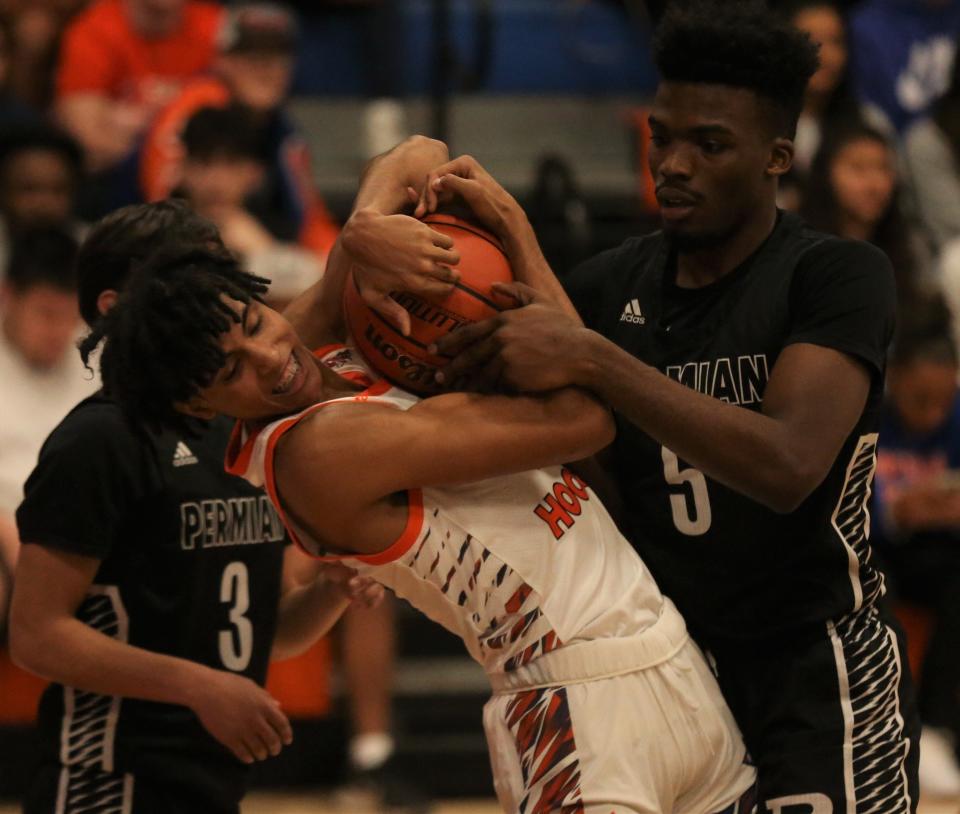 San Angelo Central High School's Chace Fields, center, fights for possession of the ball against Odessa Permian in a boys basketball game at Babe Didrikson gym on Friday, Jan. 7, 2022.