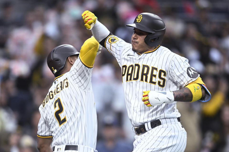 San Diego Padres' Manny Machado, right, is congratulated by Xander Bogaerts (2) after hitting a solo home run during the third inning of the team's baseball game against the Cleveland Guardians on Wednesday, June 14, 2023, in San Diego. (AP Photo/Denis Poroy)