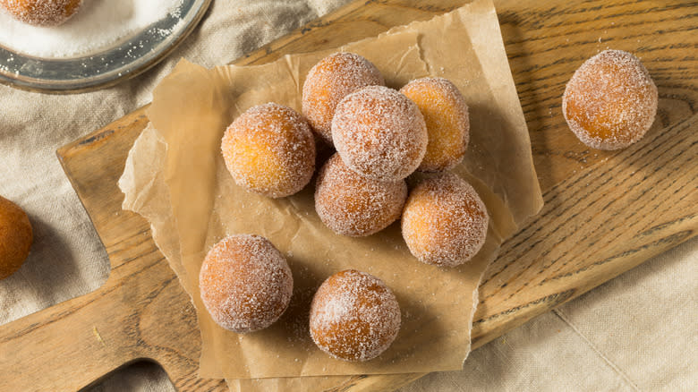 Top-down view of donut holes with cinnamon sugar coating 