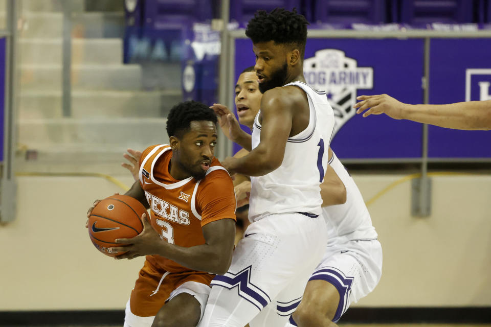 Texas guard Courtney Ramey (3) looks to pass as he is defended by TCU guard Mike Miles (1) and forward Jaedon LeDee (23) during the second half of an NCAA college basketball game in Fort Worth, Texas, Sunday, March 7, 2021. (AP Photo/Michael Ainsworth)