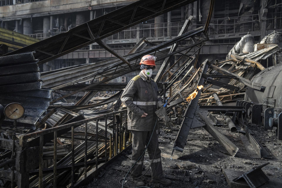 A worker clears the rubble at DTEK's power plant which was hit by a Russian missile in Ukraine, on Tuesday, April 2, 2024. Russia is attacking Ukraine’s energy sector with renewed intensity and alarming accuracy, signaling to Ukrainian officials that Russia is armed with better intelligence and fresh tactics in its campaign to annihilate the country’s power generation capacity. (AP Photo/Evgeniy Maloletka)
