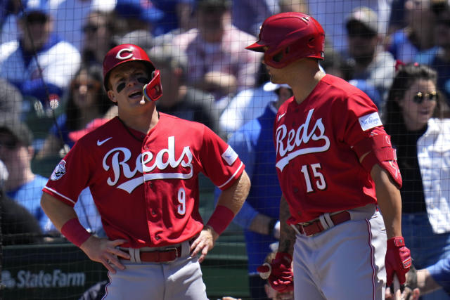 Cincinnati Reds' Matt McLain, left, talks with Nick Senzel after McClain scored a run during the first inning of a baseball game against the Chicago Cubs Friday, May 26, 2023, in Chicago. (AP Photo/Erin Hooley)