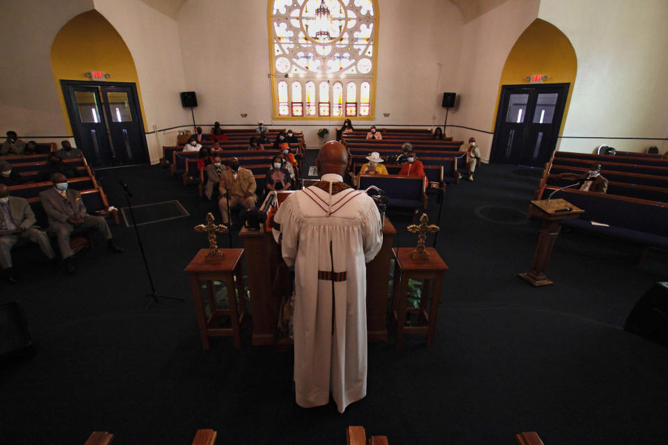 In this May 9, 2021, photo, Rev. Joseph Jackson Jr. talks to his congregation at Friendship Missionary Baptist Church in Milwaukee during a service. He is president of the board of directors for Milwaukee Inner City Congregations Allied for Hope, which along with Pastors United, Souls to the Polls and the local health clinic Health Connections, is working to get vaccination clinics into churches to help vaccinate the Black community. He's also been urging his congregation during Sunday services to get vaccinated. (AP Photo/Carrie Antlfinger)