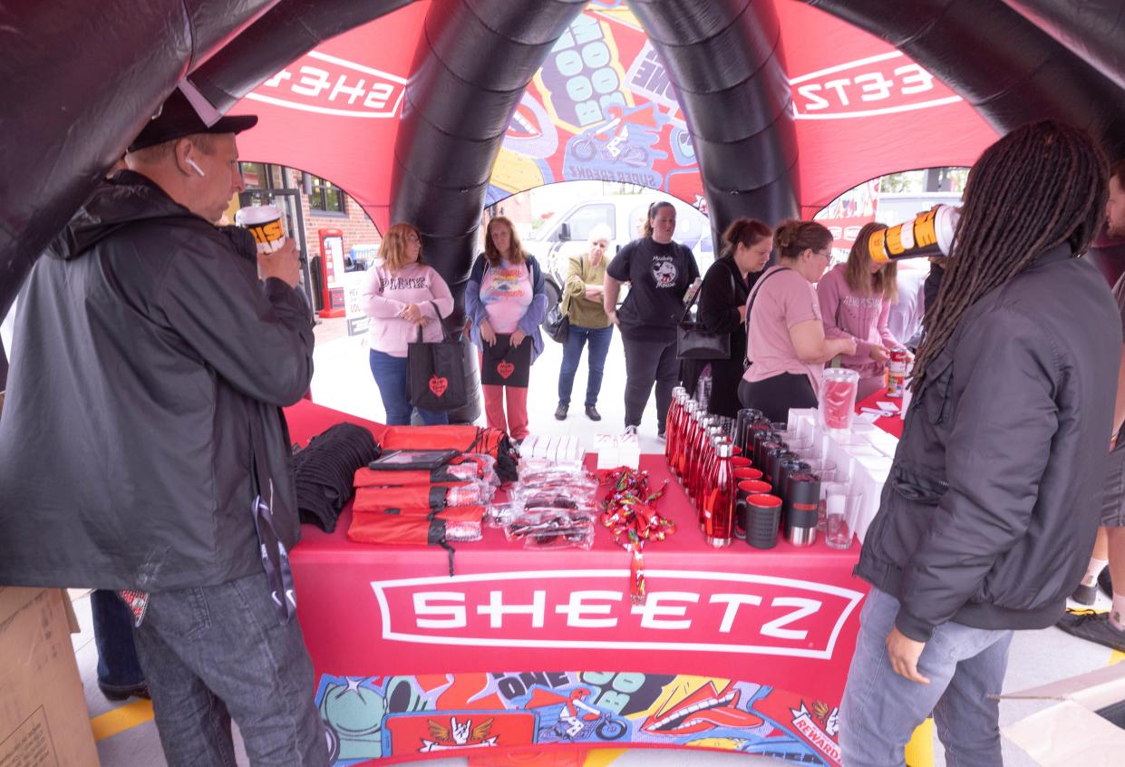 Customers lineup Thursday morning for a giveaway event at the new Sheetz convenient store and fueling center at 3544 Erie Ave. SW in Perry Township near the Massillon Menard's. The store's grand opening was Thursday.