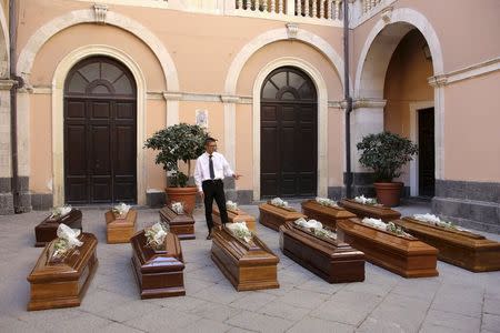 Coffins of 13 unidentified migrants who died in the April 19, 2015 shipwreck, are seen during an inter-faith funeral service in Catania, Italy July 7, 2015. REUTERS/Antonio Parrinello