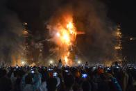 <p>Indian Hindu devotees watch an effigy of the Hindu demon king Ravana, stuffed with fire-crackers, burn in Amritsar on Sept. 30, 2017, on the occasion of the Hindu festival of Dussehra. Held at the end of the Navratri (nine nights) Festival, Dussehra symbolises the victory of good over evil in Hindu mythology. On the night of Dussehra, fire-crackers and stuffed effigies of Ravana are set alight in open grounds across the country. (Photo: Narinder Nanu/AFP/Getty Images) </p>