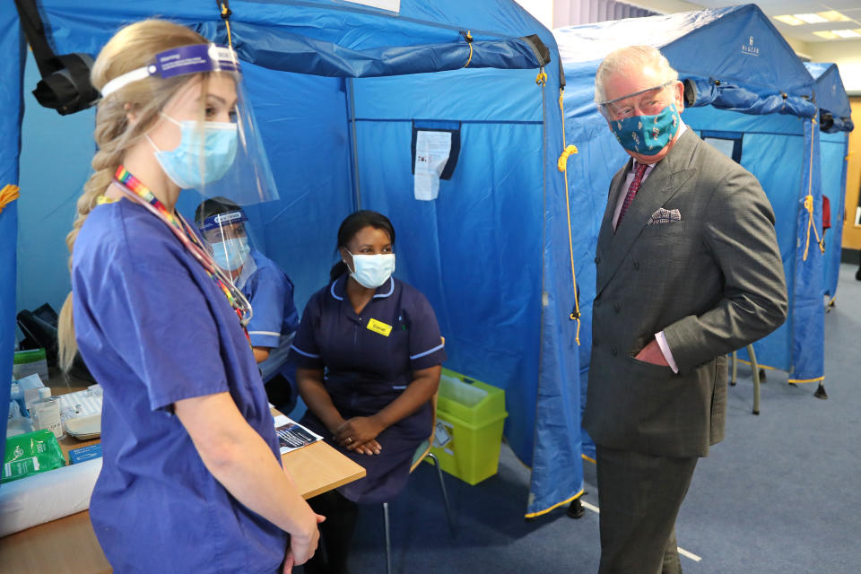 GLOUCESTER, ENGLAND - DECEMBER 17: Prince Charles, Prince of Wales wears a face-mask and protective glasses while speaking with NHS staff involved in the vaccination programme during a visit to Gloucestershire Vaccination Centre at Gloucestershire Royal Hospital on December 17, 2020 in Gloucester, England. Gloucestershire Hospitals NHS Foundation Trust is one of the largest non-specialist Trust’s in England, The Trust is the designated Management and Coordination Centre for the roll out of the COVID-19 Vaccination Programme for Gloucestershire. Their Royal Highnesses The Prince of Wales and The Duchess of Cornwall previously visited Gloucestershire Royal Hospital in June of this year, the first engagement outside of a Royal residence by any Member of the Royal Family following the first national lockdown. (Photo by Chris Jackson/Getty Images)