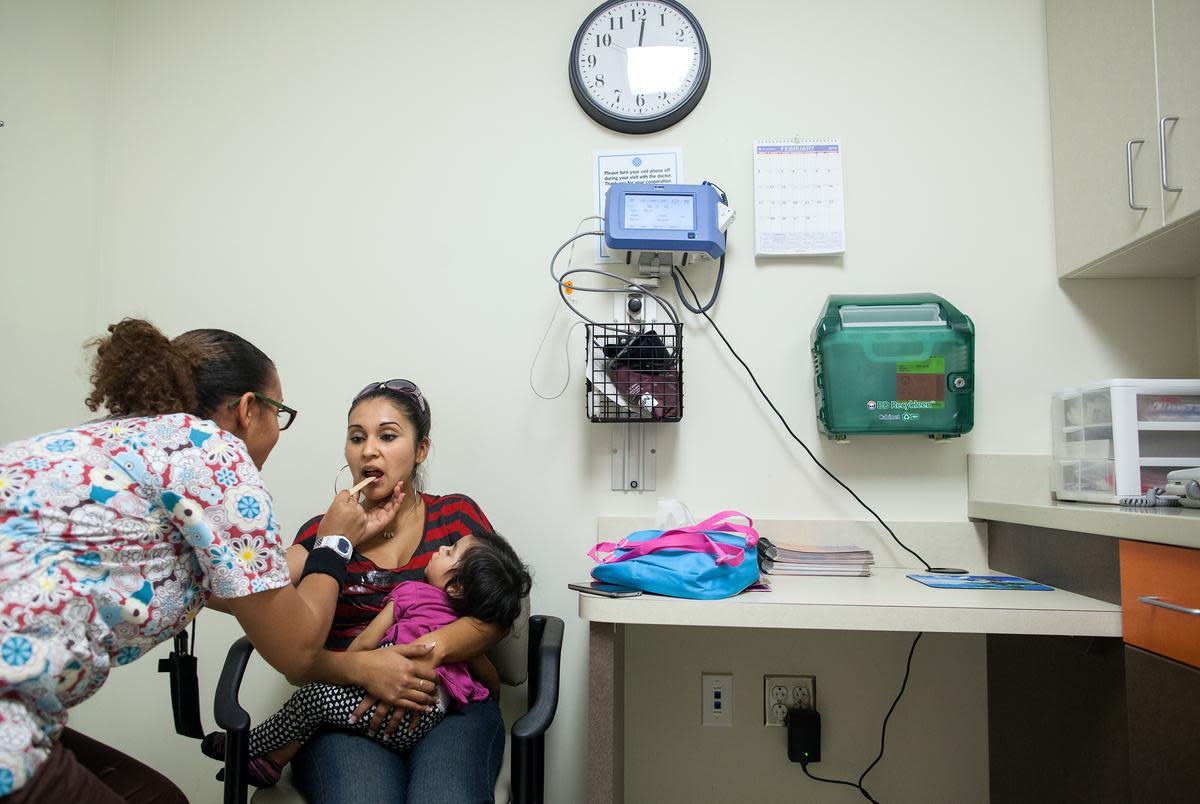 Medical assistant Alesia Bolden checks Nereyda Penaloza's vital signs during a visit to Women's Services at CommUnityCare, a federally qualified health center, Feb. 25, 2013, in Austin.