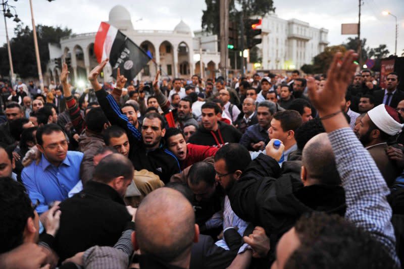 Egyptian supporters of the President Mohamed Morsi scuffle with Egyptian opposition protesters in Cairo, Egypt, on December 5, 2012. Less than a week earlier, In 2012, lawmakers passed a Constitutional Declaration that gave Morsi near-absolute power. File Photo by Karem Ahmad/UPI