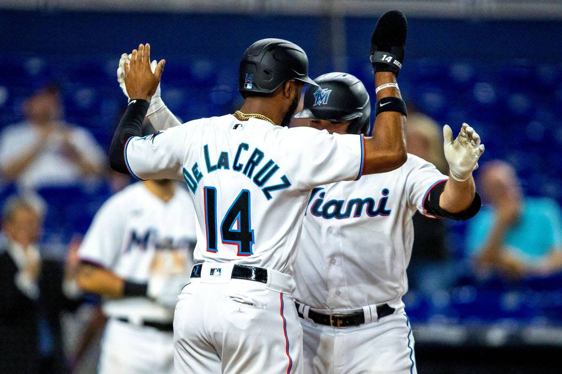 Miami Marlins base runner Nick Fortes (54) reacts with teammate Bryan De La Cruz (14) after the pair scored off a Fortes home run during the fifth inning of an MLB game against the Chicago Cubs at loanDepot park in the Little Havana neighborhood of Miami, Florida, on Wednesday, September 21, 2022.