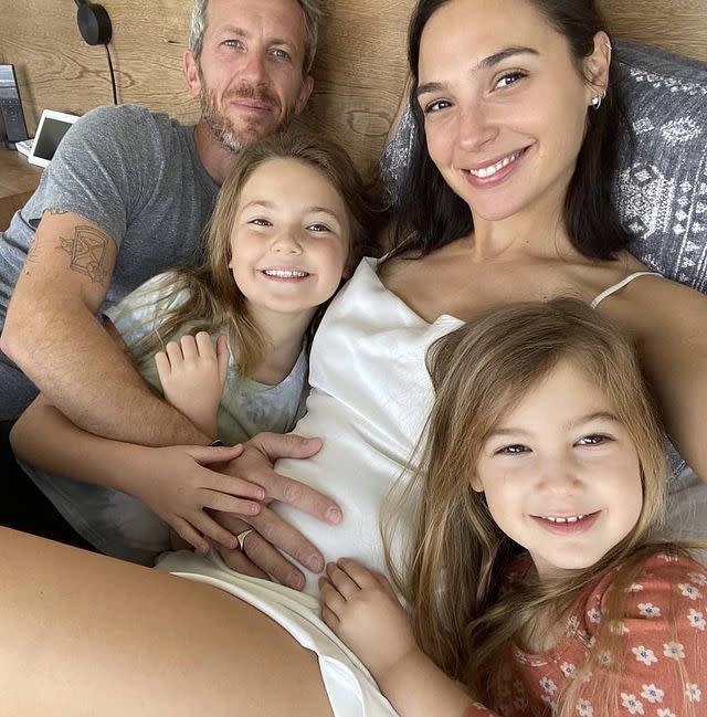 <p>Wonder Woman star Gal Gadot has revealed that she is pregnant with her third child.</p><p>The 35-year-old posted a photo announcing the exciting news on Instagram on March 1. The family picture features a Gadot, dressed in a white slip dress, snuggled up in bed with her husband Yaron Varsano and their two daughters, Maya and Alma. </p><p>The DC Comics actor captioned the photo 'Here we go again' and a series of emojis, including a blue Nazar amulet, which is believed to protect against the evil eye. <br></p><p><a href="https://www.instagram.com/p/CL4gL66BkgF/" rel="nofollow noopener" target="_blank" data-ylk="slk:See the original post on Instagram;elm:context_link;itc:0;sec:content-canvas" class="link ">See the original post on Instagram</a></p>