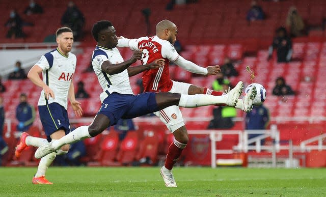 Davinson Sanchez, left, fouled Alexandre Lacazette, who converted the winning penalty