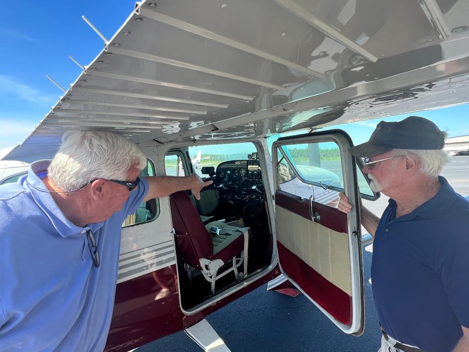 Rich Largent (right) shows Greg Vaughn the inside of his airplane at Cape Fear Regional Jetport on Friday, July 21, 2023.