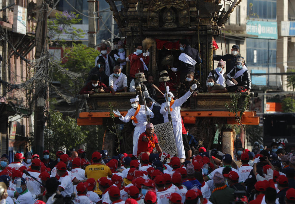 Nepalese devotees pull a chariot during the Rato Machindranath chariot festival in Lalitpur, Nepal, Saturday, May 15, 2021. A truncated version of a Hindu chariot festival took place in Nepal's capital on Saturday amid strict COVID-19 restrictions, following an agreement between organizers and authorities that prevented a repeat of violent confrontations between police and protesters at last year's festival. (AP Photo/Niranjan Shrestha)