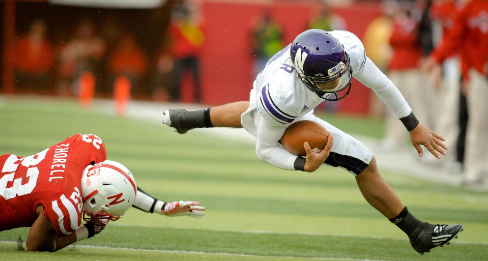 LINCOLN, NE - NOVEMBER 5: Quarterback Kain Colter #2 of the Northwestern Wildcats is tripped up by defensive back Lance Thorell #23 of the Nebraska Cornhuskers during their game at Memorial Stadium November 5, 2011 in Lincoln, Nebraska. Northwestern beat Nebraska 28-25. (Photo by Eric Francis/Getty Images)