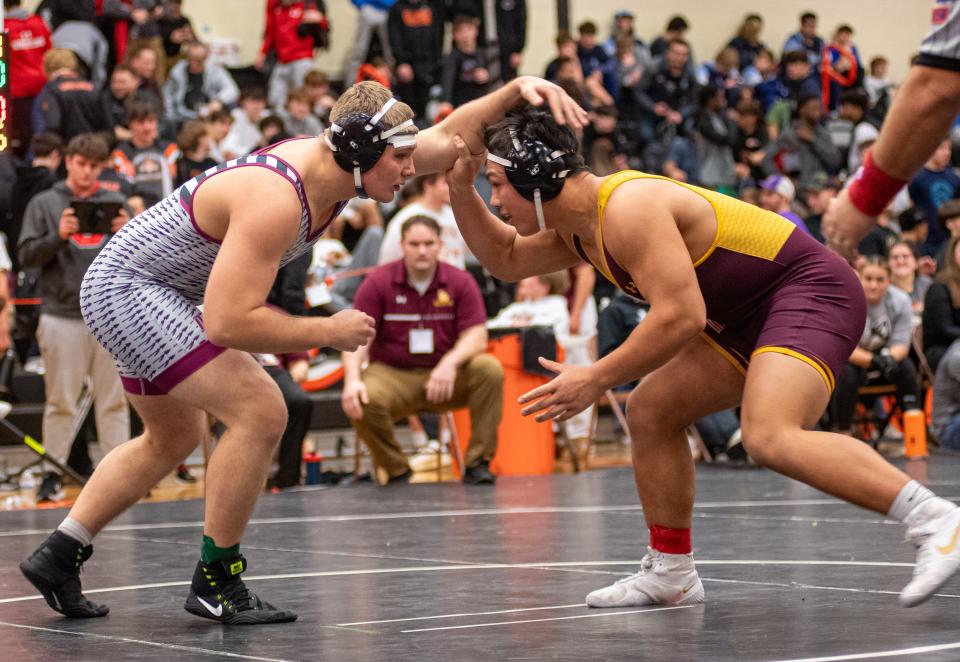 Dakota's Noah Wenzel, right, looks for an advantage to take down Loyola Acadamy's Kai Calcutt in the 215-pound class of the Dvorak Invitational Wrestling Tournament on Sunday, Dec. 16 2023, at Harlem High School in Loves Park. Wenzel won the match by default after Calcutt was injured during the match.