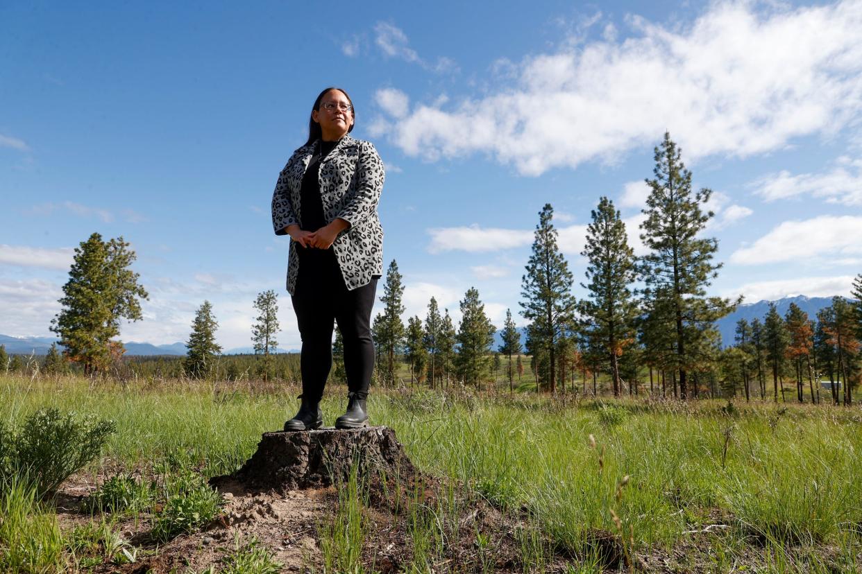 Michelle Shortridge of the Aq'am First Nations community stands at the Canadian Rockies International Airport, stands in an area that was part of a prescribed burn at the airport to help rid the forest area of fuel that would feed a potential fire from dried leaves to twigs and dried pine needles in Cranbrook, British Columbia, Canada on Thursday, May 30, 2024.