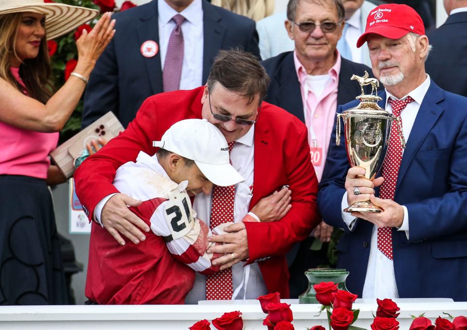 Rich Strike's trainer Eric R. Reed hugs jockey Sonny Leon after winning the 148th Kentucky Derby Saturday at Churchill Downs. At right is owner Richard Dawson of RED TR-Racing. May 7, 2022