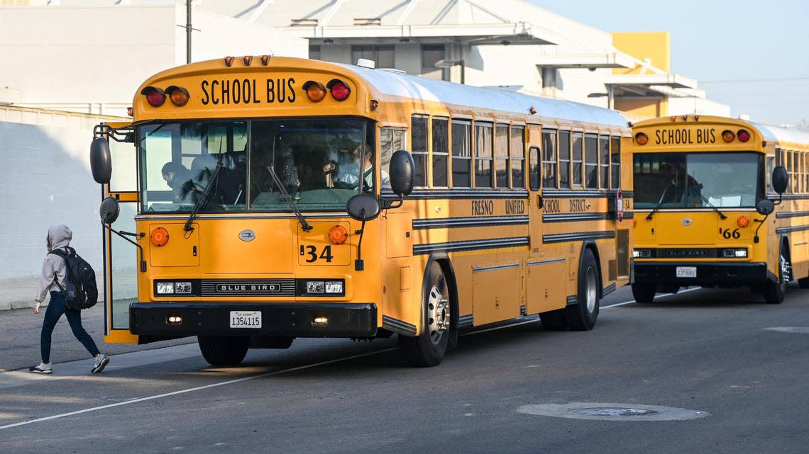 Fresno Unified School District buses arrive at Edison High School to let students off before classes on Friday, Feb. 10, 2023.