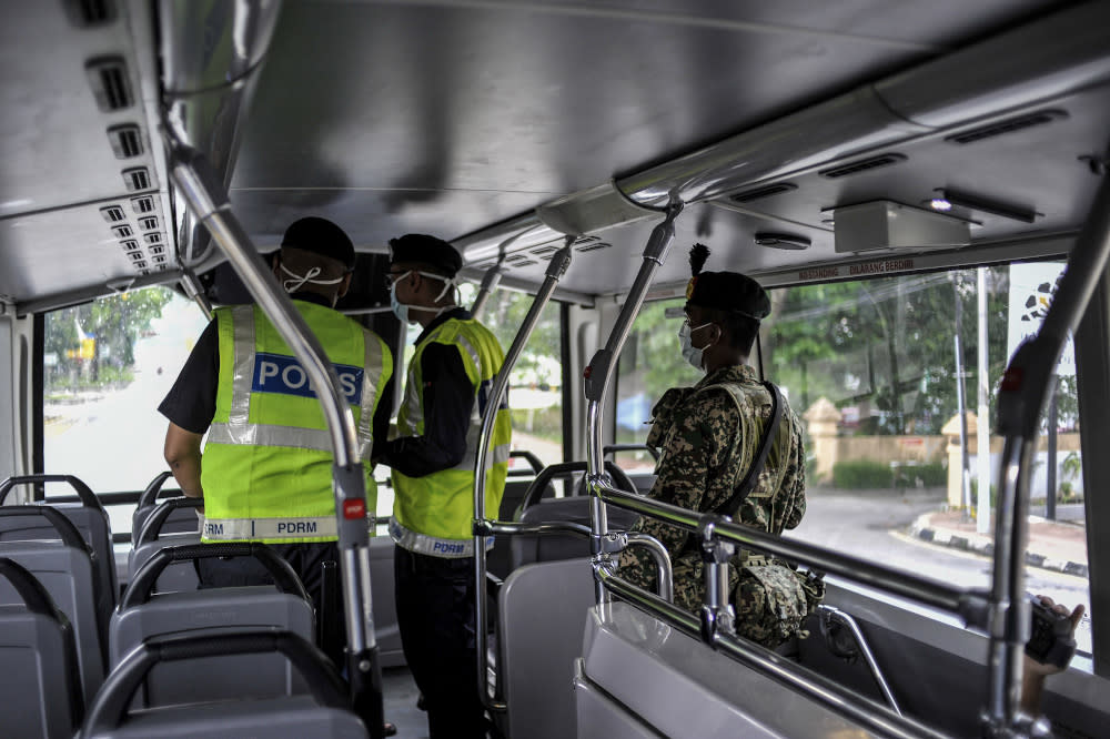 Malaysian Armed Forces and police personnel are seen at one of the roadblocks in Kuala Lumpur March 22, 2020. — Picture by Shafwan Zaidon