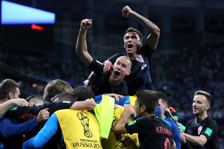 Croatia's Domagoj Vida and Mario Mandzukic celebrate with team mates after Luka Modric scored their second goal. REUTERS/Ivan Alvarado