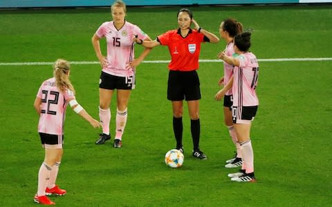 Scotland players remonstrate with referee Ri Hyang-ok as she awaits a VAR review - Credit: REUTERS