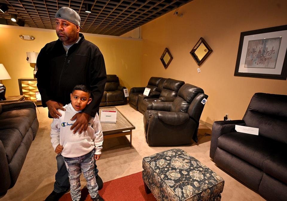 Luis Santiago of Worcester shops with his son, Daniel, 6, at Rotmans during the longtime Southbridge Street furniture store's going-out-of-business liquidation sale.