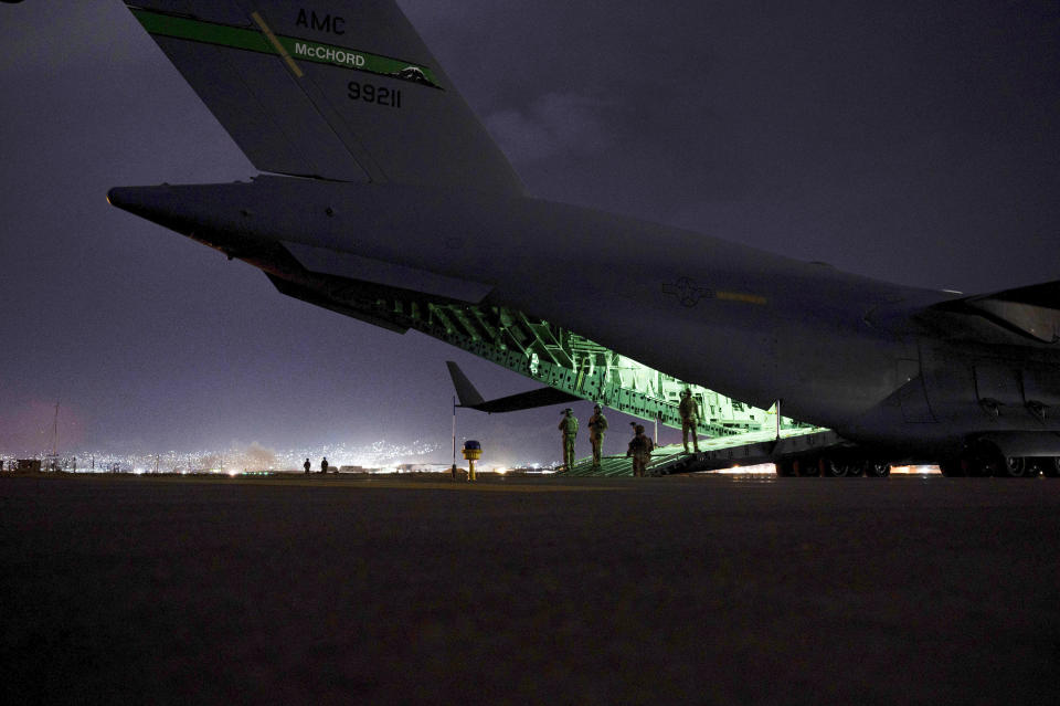 In this Aug. 30, 2021, photo provided by the U.S. Air Force, a Air Force aircrew, assigned to the 816th Expeditionary Airlift Squadron, prepares to receive soldiers, assigned to the 82nd Airborne Division, to board a U.S. Air Force C-17 Globemaster III aircraft in support of the final noncombatant evacuation operation missions at Hamid Karzai International Airport in Kabul Afghanistan. (Senior Airman Taylor Crul/U.S. Air Force via AP)