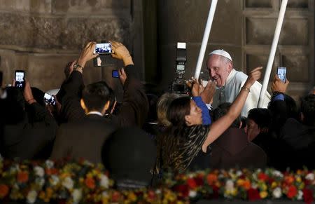 Pope Francis greets the faithful after a meeting with members of the civil society at the San Francisco Church in Quito, Ecuador, July 7, 2015. REUTERS/Jose Miguel Gomez