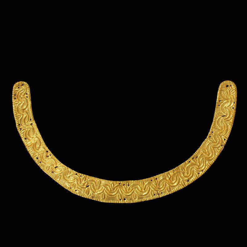 A U-shaped repousse gold ornament used for attachment to furniture or clothing is displayed in this undated handout picture