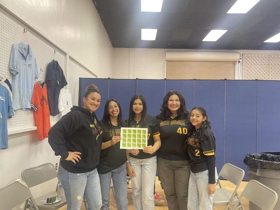 Stagg softball head coach and players pose with helmet stickers that read "Long Live Lala." The team received the stickers on Saturday, March 25, 2023 during the Greater San Joaquin Softball District Hall of Fame.