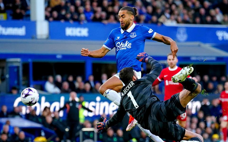 Everton's Dominic Calvert-Lewin is brought down by Liverpool goalkeeper Alisson Becker