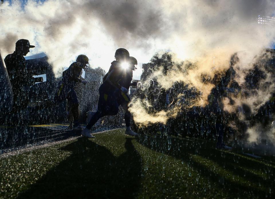 The Delaware Blue Hens take the field before a 35-3 win against Hampton at Delaware Stadium, Saturday, Sept. 24, 2022.