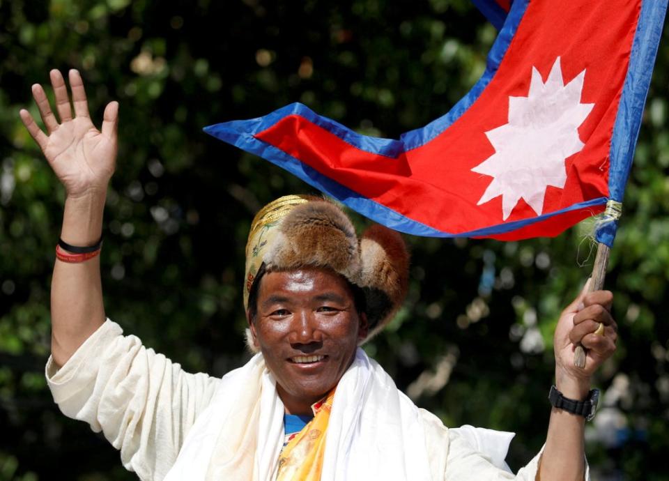 Nepali mountaineer Kami Rita Sherpa waves towards media (REUTERS)