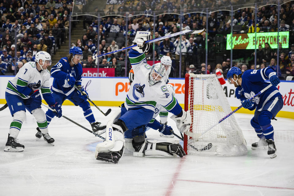 Toronto Maple Leafs right wing William Nylander, right, scores on Vancouver Canucks goaltender Thatcher Demko (35) during the second period of an NHL hockey match in Toronto on Saturday, Nov. 11, 2023. (Christopher Katsarov/The Canadian Press via AP)