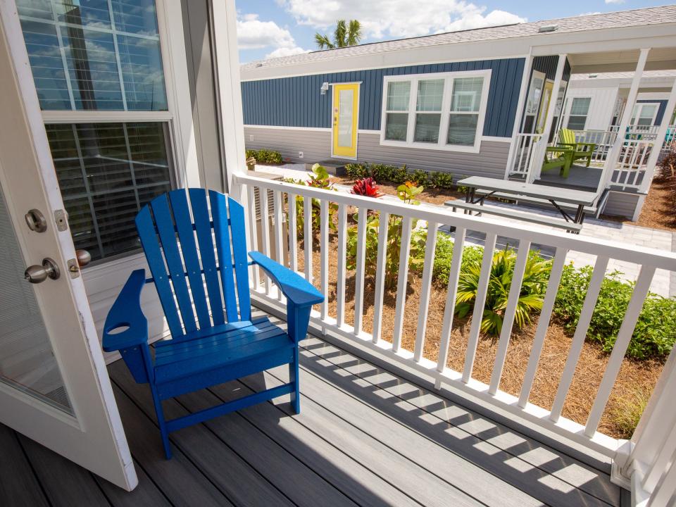 The patio on the cabana cabin with a blue lounge chair.