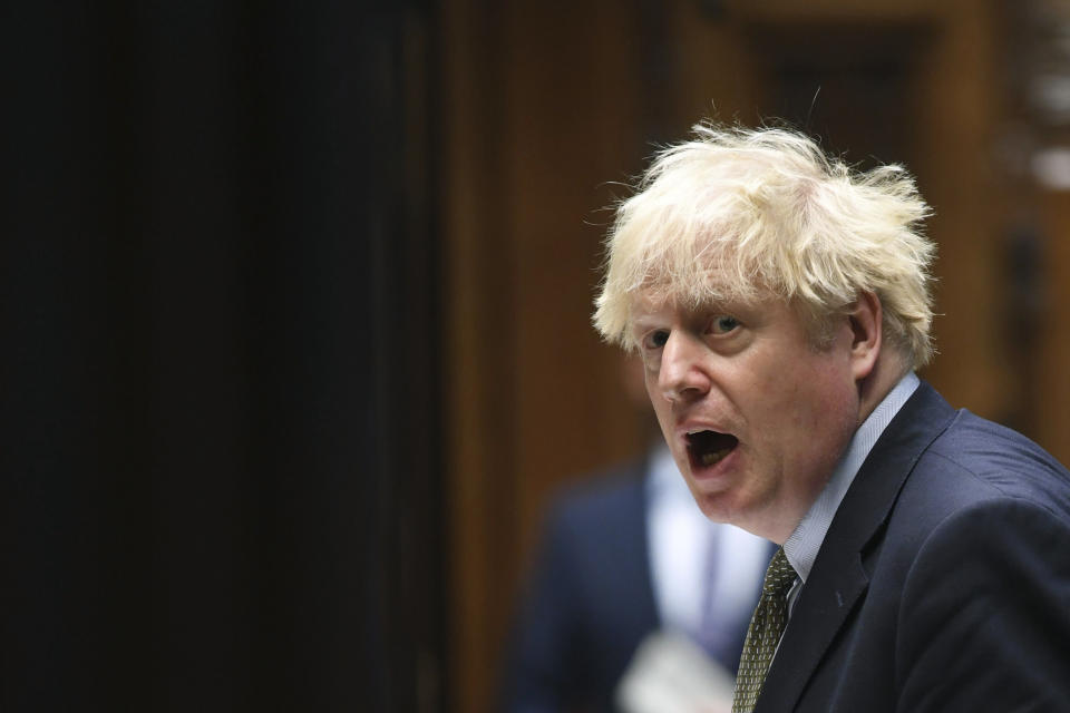 In this photo released by UK Parliament, Britain's Prime Minister Boris Johnson speaks, during Prime Minister's Questions in the House of Commons, London, Wednesday, Oct. 14, 2020. Johnson is being criticized by all sides two days after announcing his three-tier approach. A report Tuesday showed that the government’s science advisers had urged it to impose much tougher measures, including a two- to three-week national lockdown. (Jessica Taylor/UK Parliament via AP)