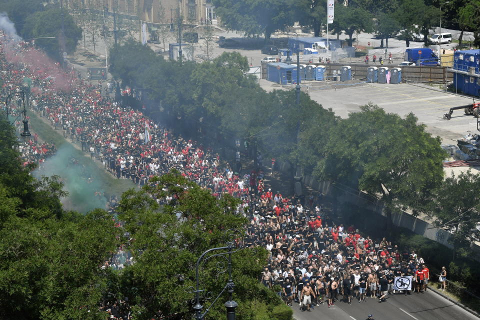 FILE - Hungarian fans march towards the Puskas Arena in Budapest, Hungary, Saturday, June 19, 2021, just hours before Hungary will face France in their Euro 2020 group F soccer match. Among the thousands of fans in the stands at Europe's biggest soccer games are a few people operating undercover. Trained volunteer observers listen for racist chants and watch for extremist symbols on banners. (Zoltan Mathe/MTI via AP, File)