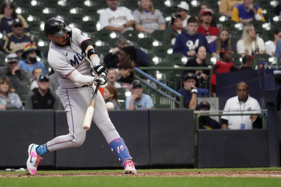 Miami Marlins' Miguel Rojas hits an RBI-single during the 12th inning of a baseball game against the Milwaukee Brewers, Sunday, Oct. 2, 2022, in Milwaukee. (AP Photo/Aaron Gash)