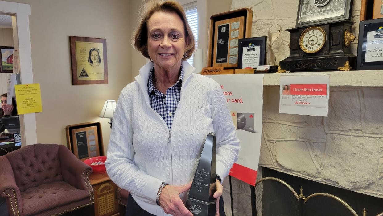 Local State Farm agent Judy Stroud poses with her Chamber of Commerce G. Ray Cantrell Award at her office on Tuesday.