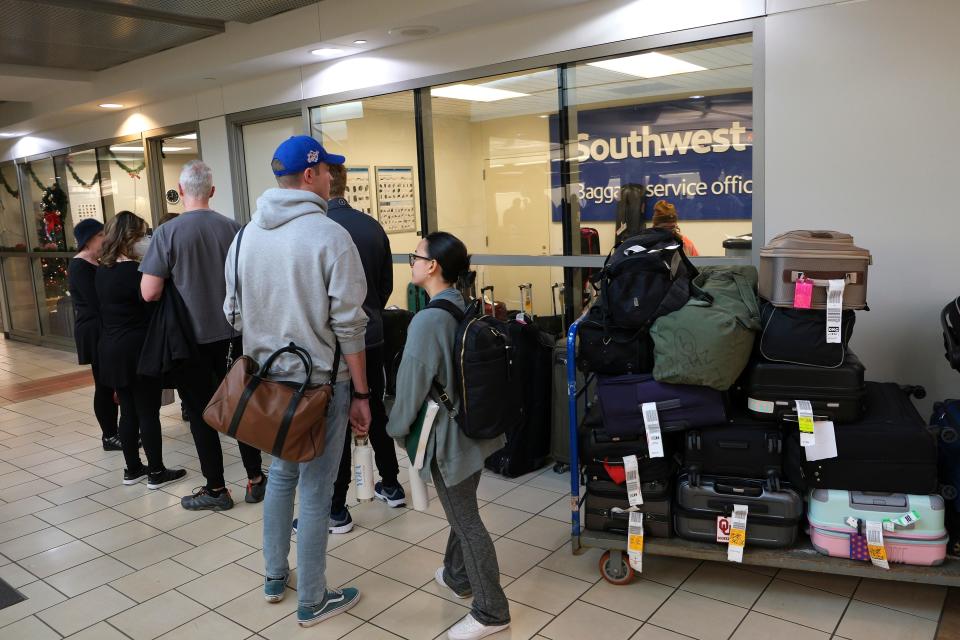 People line up Tuesday at the Southwest Airlines Baggage Service Office at Will Rogers World Airport in Oklahoma City.