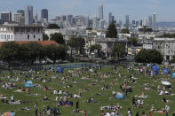 Visitors set up inside circles designed to help prevent the spread of the coronavirus by encouraging social distancing at Dolores Park in San Francisco, Sunday, May 24, 2020. (AP Photo/Jeff Chiu)