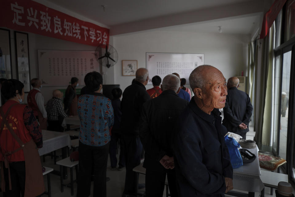 An elderly man looks out as he and others arrive to Kang's canteen, the Harmonious and Happy Home for a free vegetarian lunch in Dingxing, southwest of Beijing Thursday, May 13, 2021. China's leaders are easing limits on how many children each couple can have, hoping to counter the rapid aging of Chinese society.(AP Photo/Andy Wong)