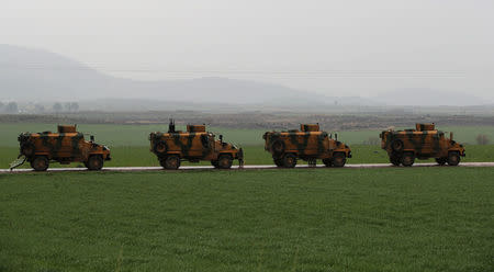 Turkish army vehicles are pictured near the Turkish-Syrian border in Hatay province, Turkey January 23, 2018. REUTERS/Umit Bektas