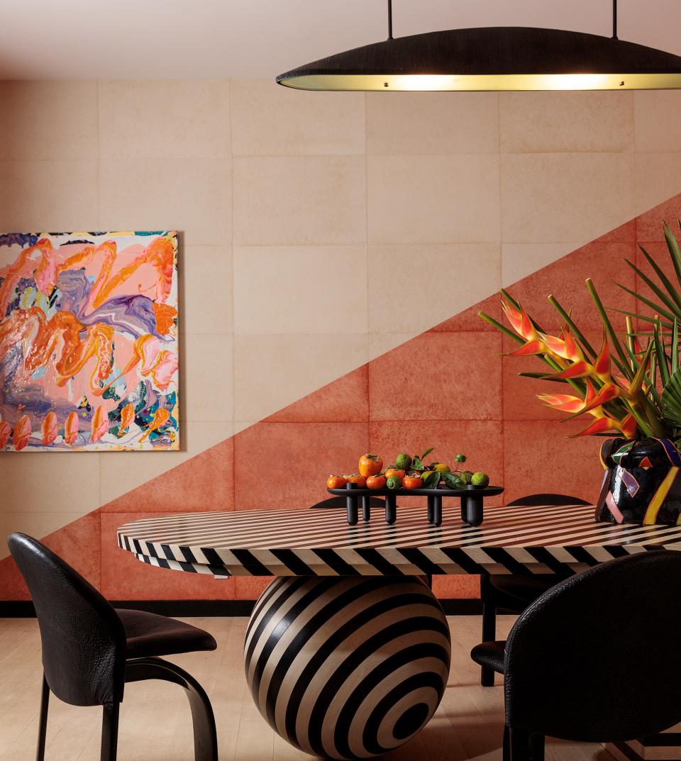 A dining room with pink and black