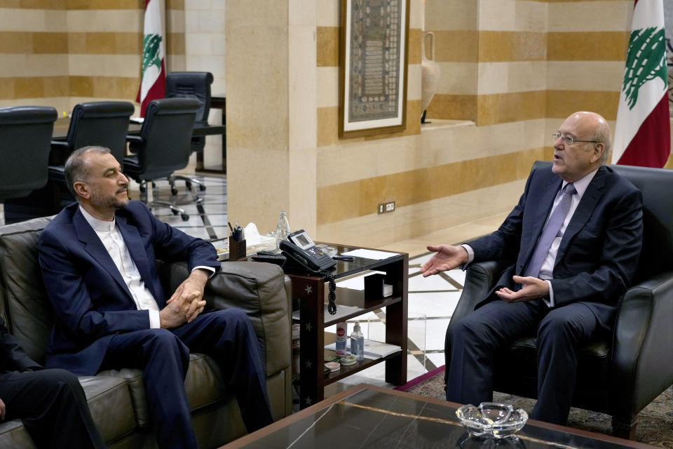 Lebanese caretaker Prime Minister Najib Mikati, right, meets with Iranian Foreign Minister Hossein Amirabdollahian in Beirut, Lebanon, Friday, Jan. 13, 2023. Amirabdollahian said talks between regional rivals Iran and Saudi Arabia are continuing and could eventually restore diplomatic relations that were severed years ago. (AP Photo/Bilal Hussein)