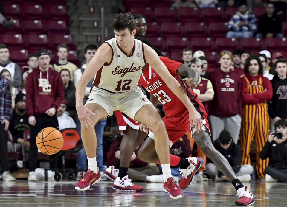 Boston College's Quinten Post (12) defends the ball from North Carolina State during the first half of an NCAA college basketball game, Saturday, Feb. 11, 2023, in Boston. (AP Photo/Mark Stockwell)