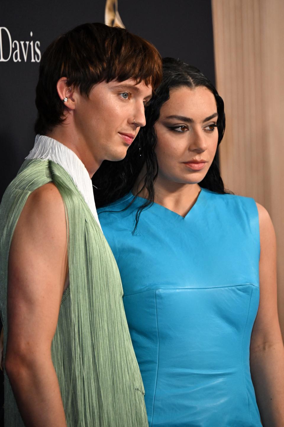 Australian singer Troye Sivan and British singer Charli XCX arrive for the Recording Academy and Clive Davis' Salute To Industry Icons pre-Grammy gala at the Beverly Hilton hotel in Beverly Hills, California on February 3, 2024.