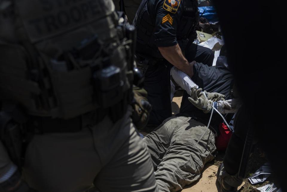 A University of Texas Police Department officer arrests a pro-Palestinian protester from an encampment set up on the campus’ South Lawn on Monday, April 29, 2024, in Austin.